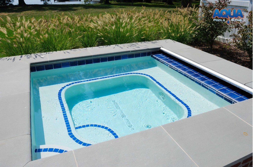 This custom hot tub features an automatic cover.